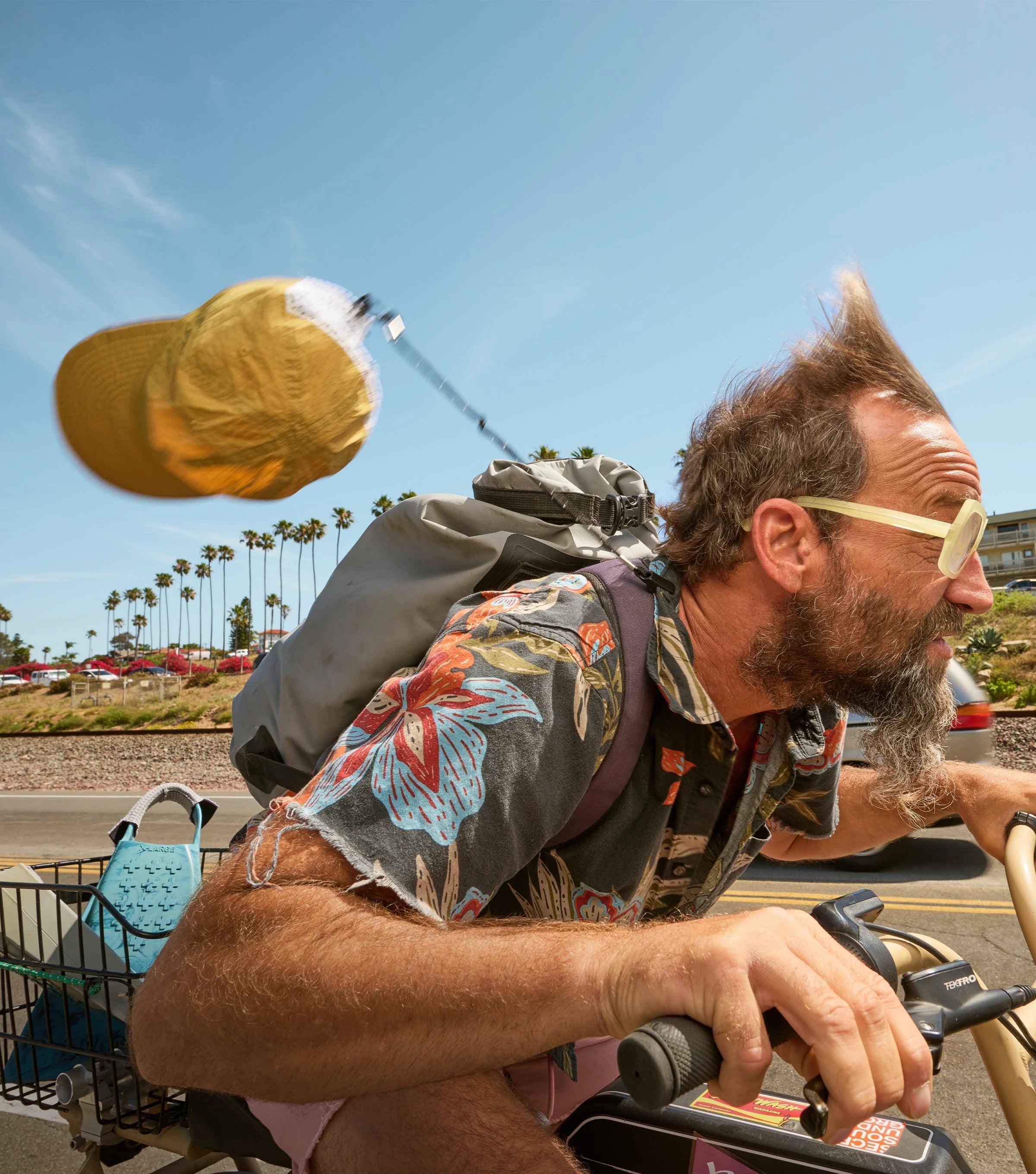 Man riding a motorcycle with a yellow cap in the air